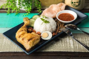 Fragrant coconut rice served with a choice of curry, accompanied by anchovies, peanut, homemade sambal, hard-boiled egg, cucumber and prawn cracker