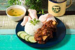 Indonesian turmeric marinated and smashed beef ribs served with rice, cucumber, shrimp sauce, and prawn cracker