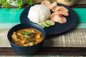 Mildly spiced curry chicken served with potatoes, prawn chips, cucumber and aromatic rice.