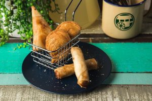 Finger food platter included 1 samosa, 2 spring rolls, and 3 curry puffs.