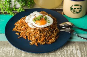 Indonesian fried rice with Choice of Protein, fish cake (except Vegetable option), carrot and cabbage cooked with homemade soy sauce and served with a sunny side egg.